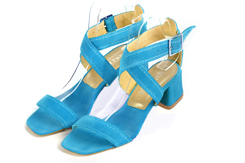 Turquoise blue women's fully open sandals, with crossed straps. Square toe. Low flare heels. Front view - Florence KOOIJMAN